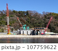 【工事現場】河川敷に積まれた土嚢とクレーン (リニア架橋工事) 107759622