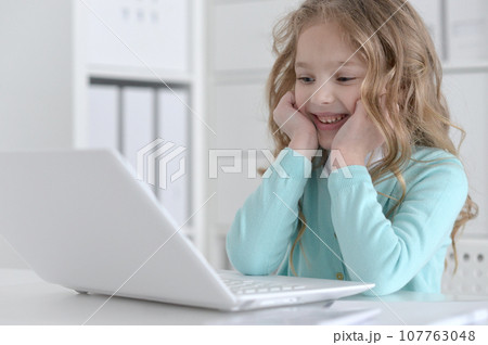 Cute and happy little girl children using laptop computer 107763048