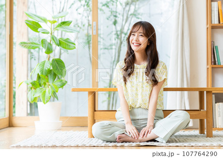 リビングでくつろぐ若い女性 リビングでくつろぐ若い女性 107764290