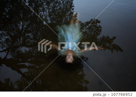a girl in a blue dress under the water.suicide of a woman on the lake 107766952