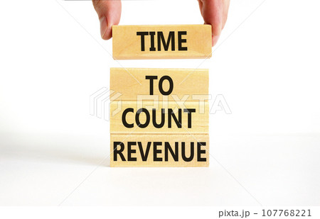 Time to count revenue symbol. Concept word Time to count revenue on wooden blocks. Businessman hand. Beautiful white table white background. Business and time to count revenue concept. Copy space. 107768221