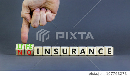 Life or no insurance symbol. Concept words Life insurance No insurance on wooden blocks. Beautiful grey table grey background. Businessman hand. Business Life or no insurance concept. Copy space. Life or no insurance symbol. Concept words Life insurance No insurance on wooden blocks. Beautiful grey table grey background. Businessman hand. Business Life or no insurance concept. Copy space. 107768278