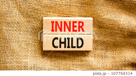 Inner child symbol. Concept words Inner child on beautiful wooden block. Beautiful canvas table canvas background. Psychological, motivational inner child concept. Copy space. 107768314