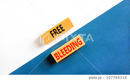 Free bleeding symbol. Concept words Free bleeding on beautiful wooden block. Beautiful white and blue background. Gen Z, motivational freedom free bleeding concept. Copy space. 107768318