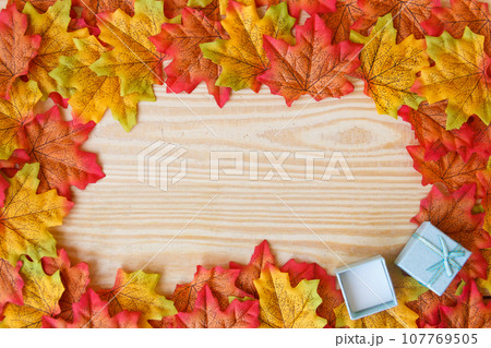 maple leaf and free space for text with wooden background. maple leaf and free space for text with wooden background. 107769505