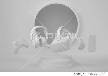 Set of video game joystick, VR glasses and headphones on monochrome podium 107770582