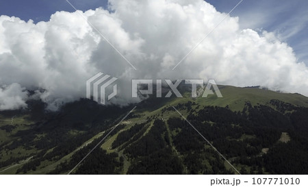 View of the Valley in early morning aerial view. Aerial view drone flying in the valley with pine tree forest in the mountain range View of the Valley in early morning aerial view. Aerial view drone flying in the valley with pine tree forest in the mountain range 107771010