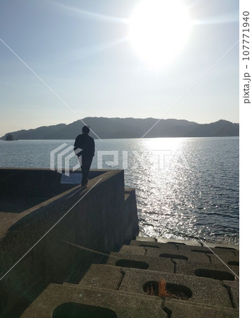 夕日を見つめる二人 107771940