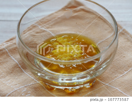 Melting natural beeswax in the bowl 107773587