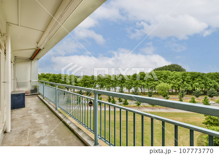 a balcony with blue sky and white clouds in the background, taken from an apartment balcony at sunset point apartments a balcony with blue sky and white clouds in the background, taken from an apartment balcony at sunset point apartments 107773770