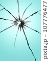 Cracked glass with a hole, broken window texture, bullet hole. 107776477