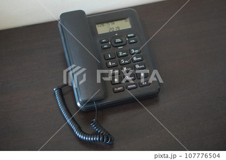 top view antique black plastic telephone on wooden table background, object, technology, copy space 107776504