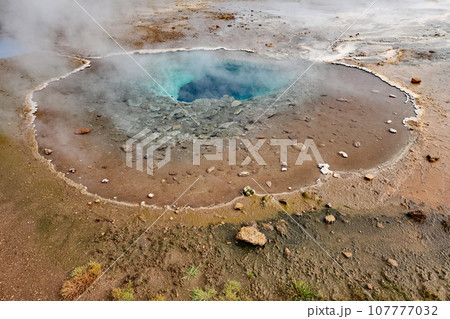 Clear blue hot spring and pool in Geysir geothermal area in Iceland. Clear blue hot spring and pool in Geysir geothermal area in Iceland. 107777032