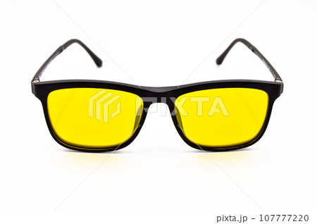 Black plastic frame yellow lens glasses, glasses isolated on white background Black plastic frame yellow lens glasses, glasses isolated on white background 107777220