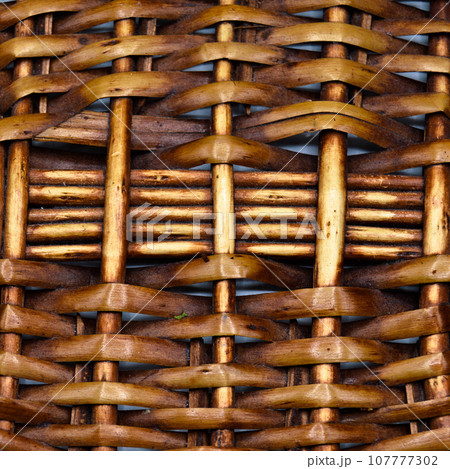 Rattan wicker texture with handmade traditional and dry branches, wicker brown texture background Rattan wicker texture with handmade traditional and dry branches, wicker brown texture background 107777302