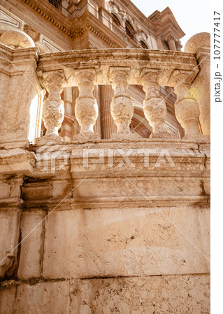 Close up view of architectural details on a famous medieval cathedral in the centre Malaga city in Spain, Europe. 107777417