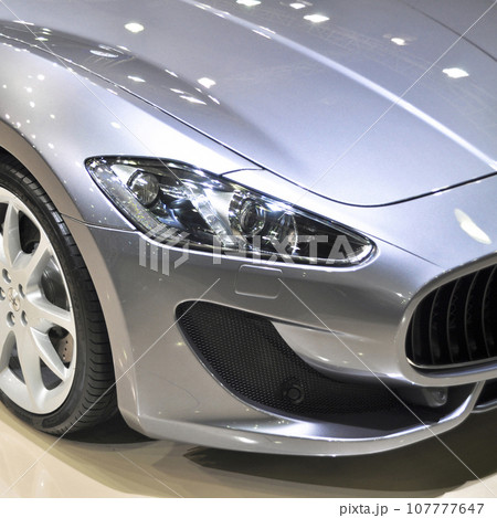 Side view of luxury and gray maserati in a showroom, November 02.2012 Istanbul Turkey International Auto Show Side view of luxury and gray maserati in a showroom, November 02.2012 Istanbul Turkey International Auto Show 107777647