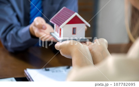 Real estate agents and buyers discuss signing a business contract, renting, buying, mortgage, loan or home insurance 107782095