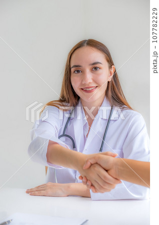 Doctors handshake after advice report health examination results and recommend medication to patients, occupational consultation medical checkup program concept Doctors handshake after advice report health examination results and recommend medication to patients, occupational consultation medical checkup program concept 107782229