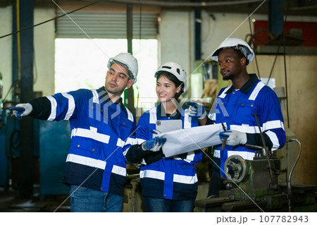 Team worker wearing uniform safety brainstorming holding blueprint plan work management Team worker wearing uniform safety brainstorming holding blueprint plan work management 107782943