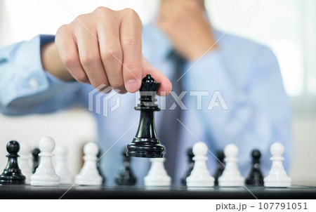 hand of businessmen moving chess in competition shows leadership, followers and business success strategies hand of businessmen moving chess in competition shows leadership, followers and business success strategies 107791051