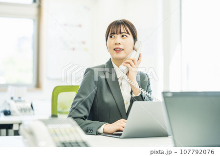 会社の電話で話す女性 会社の電話で話す女性 107792076