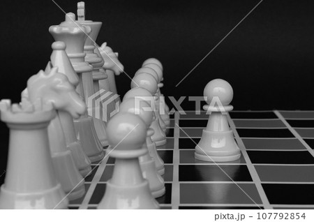 Selective view of chess pawn moving toward for battle with black and white background. Strategy and tactic concept Selective view of chess pawn moving toward for battle with black and white background. Strategy and tactic concept 107792854
