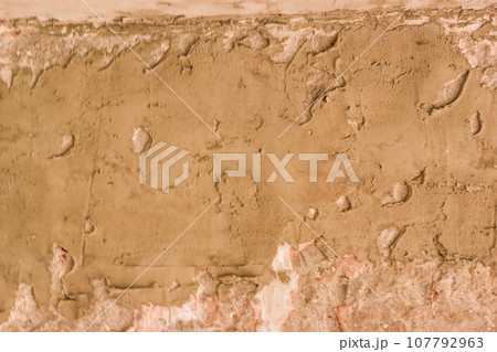 Concrete wall unevenly covered with cement. 107792963