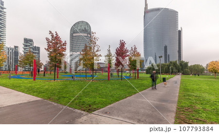 Panorama showing skyscrapers and biblioteca from park with green lawn timelapse in Milan Panorama showing skyscrapers and biblioteca from park with green lawn timelapse in Milan 107793884