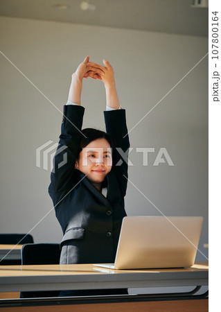 オフィスでストレッチをする若い女性 107800164