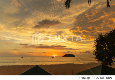 .beautiful cloud in golden sky at sunset in Kata beach Phuket Thailand. 107801609