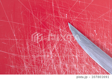 Color gradient red old plastic cutting board background with scratches Color gradient red old plastic cutting board background with scratches 107801691