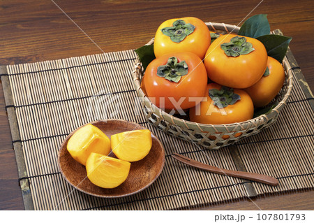 深ざるに入れて葉を添えた秋の果物柿 107801793