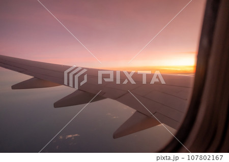 Sky, cloud during the sunrise from window of airplane. 107802167