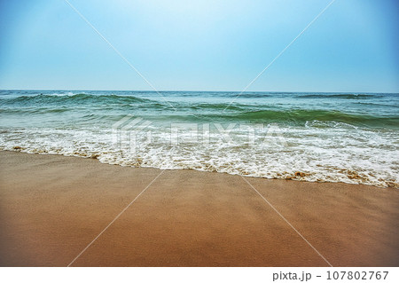 Awsome waves of  sea of East Cost of India at Puri beach of Odisha where some people enjoying sea bath with friend far from the shore. India February 2020. 107802767