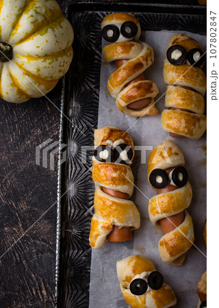 Halloween food. Ssausage in shape of mummies Halloween food. Ssausage in shape of mummies 107802847
