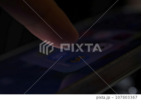 finger on phone close up finger on phone close up 107803367