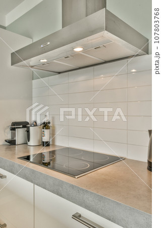 a modern kitchen with white cabinets and counter space for the stove, sink and dishwasher are visible on the wall 107803768