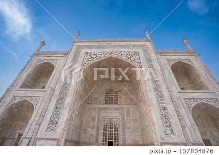 Side view of the Taj Mahal's white domes and white towers at sunset. Side view of the Taj Mahal's white domes and white towers at sunset. 107803876