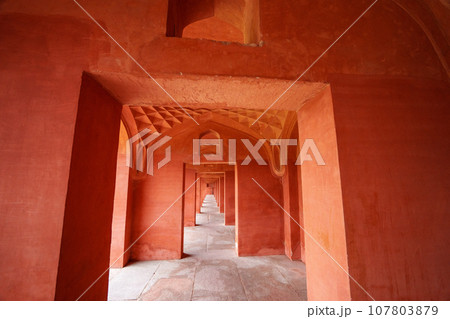 The red building has neatly arranged square doors. 107803879