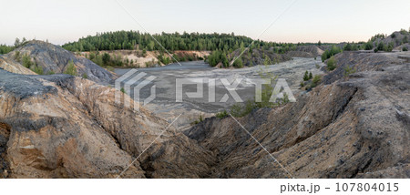 eroded soil quarry ravine with forest on its edge at summer evening panoramic photo eroded soil quarry ravine with forest on its edge at summer evening panoramic photo 107804015