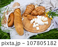 Picnic in the field with berries, juice, cheese, sausage and sweet croissants 107805182