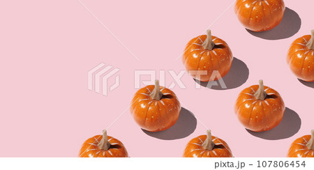 Orange pumpkin pattern on pastel color background 107806454
