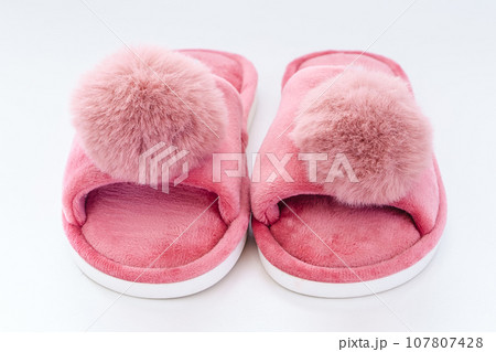Pink home fluffy slippers on white background. Comfort and warmth accessories Pink home fluffy slippers on white background. Comfort and warmth accessories 107807428