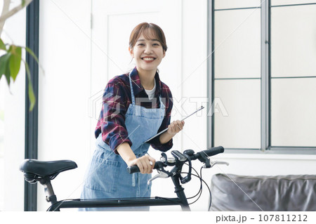 自転車を持つ女性 107811212