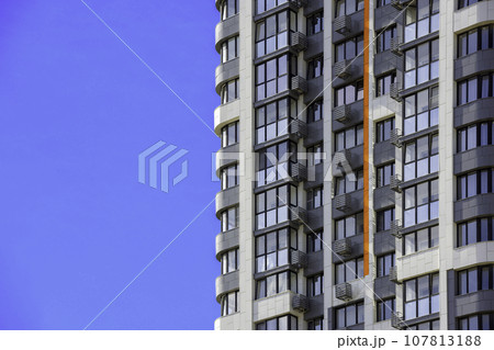 freshly built high rise apartment building on blue sky background 107813188