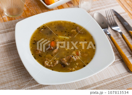 Rustic style mushroom soup in meat stock with pork and vegetables Rustic style mushroom soup in meat stock with pork and vegetables 107813534