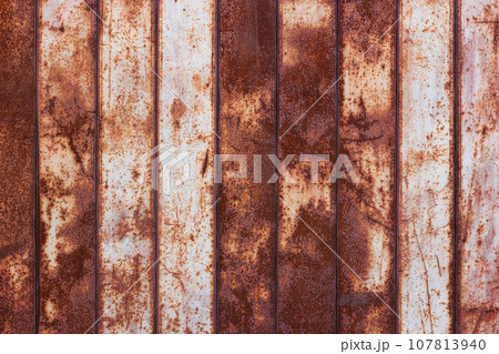 flat texture of rusty corrugated flat thin sheet metal surface with vertical structure and leftovers of white paint flat texture of rusty corrugated flat thin sheet metal surface with vertical structure and leftovers of white paint 107813940