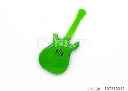 Toy guitar on white background with selective focus Toy guitar on white background with selective focus 107815232
