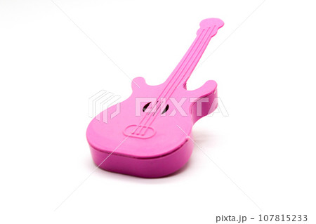 Toy guitar on white background with selective focus Toy guitar on white background with selective focus 107815233
